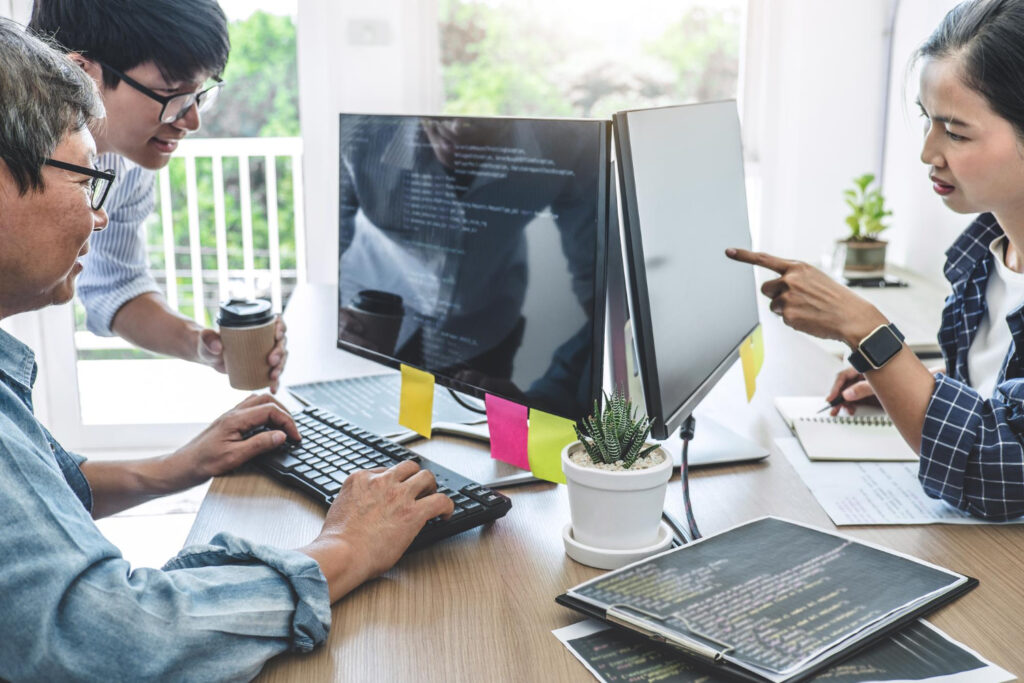 A group of employees resolving the challenges of website development project together